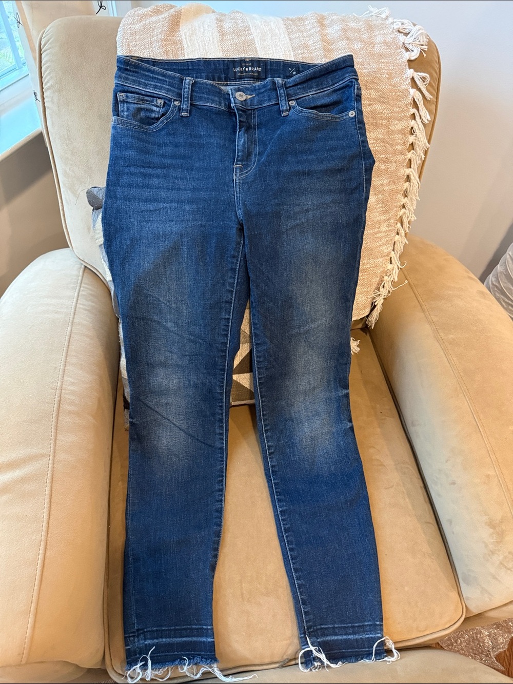 Lucky Brand Indigo Skinny Ankle Jeans with Frayed Hem.